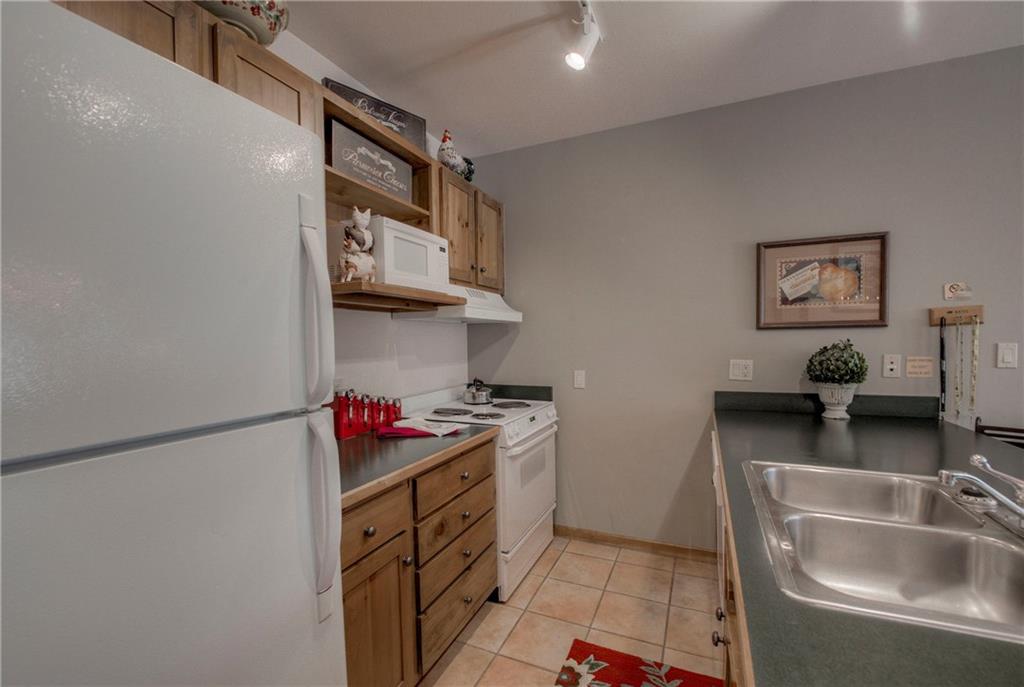 129 River Run Road, Unit 8062 Dillon, CO 80435 - Photo 11 of 35 a kitchen with stainless steel appliances granite countertop a sink stove and refrigerator