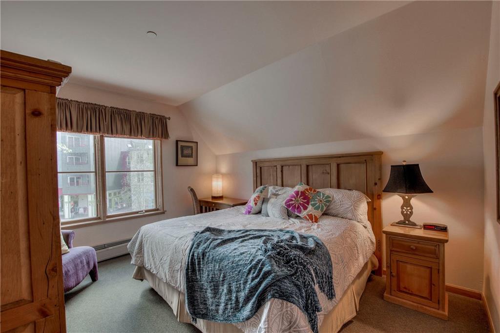 129 River Run Road, Unit 8062 Dillon, CO 80435 - Photo 15 of 35 a bedroom with a bed and a large window