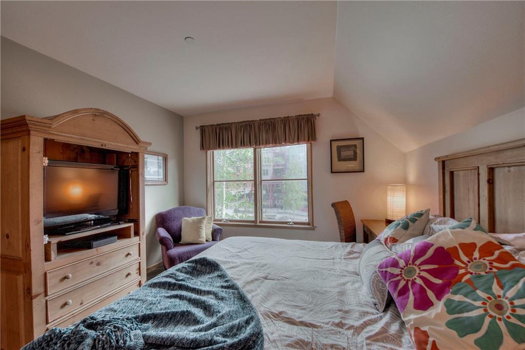 129 River Run Road, Unit 8062 Dillon, CO 80435 - Photo 16 of 35 a bedroom with a bed and a flat screen tv