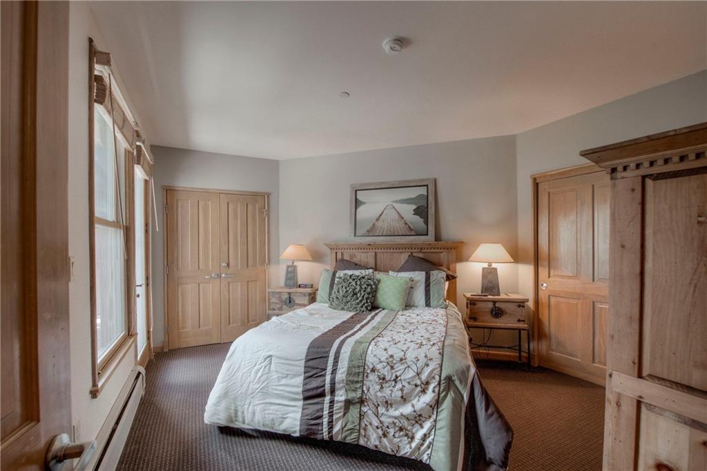 129 River Run Road, Unit 8062 Dillon, CO 80435 - Photo 18 of 35 a bedroom with a bed and a painting on the wall