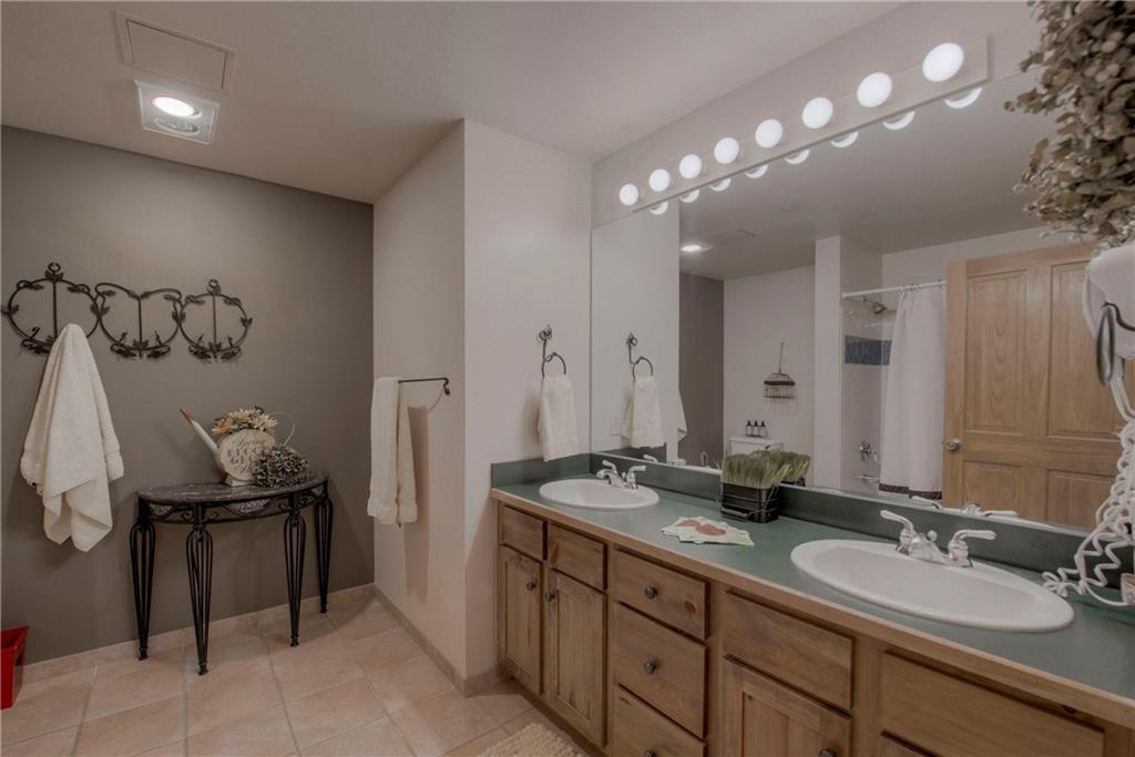 129 River Run Road, Unit 8062 Dillon, CO 80435 - Photo 21 of 35 a bathroom with a granite countertop sink a large mirror and a shower