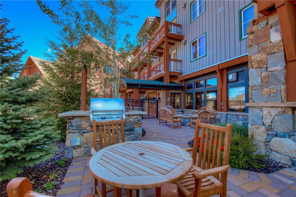 129 River Run Road, Unit 8062 Dillon, CO 80435 - Photo 24 of 35 a wooden bench sitting in front of building