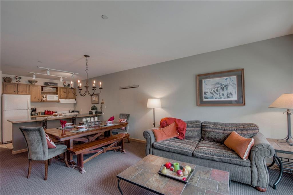 129 River Run Road, Unit 8062 Dillon, CO 80435 - Photo 7 of 35 a living room with furniture and a chandelier