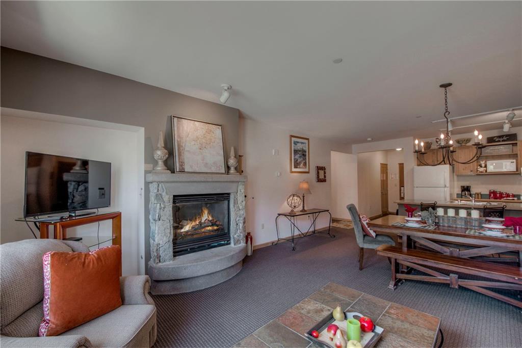 129 River Run Road, Unit 8062 Dillon, CO 80435 - Photo 8 of 35 a living room with furniture fireplace and flat screen tv
