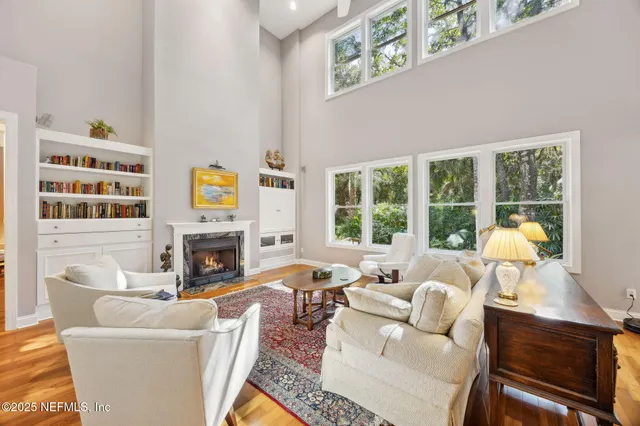 a dining room with furniture and large windows
