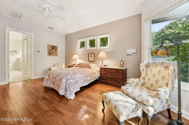 a bedroom with a bed and a chair in it