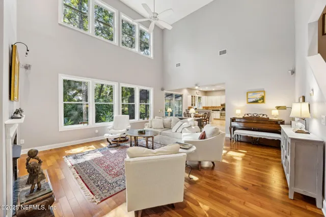 a living room with furniture a fireplace and a large window