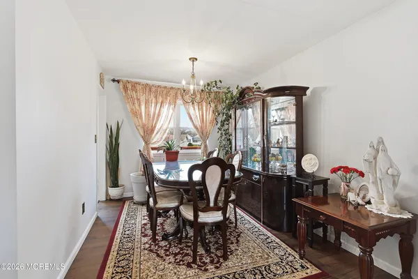 a view of a dining room with furniture and chandelier