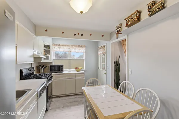 a kitchen with a stove a sink and a refrigerator