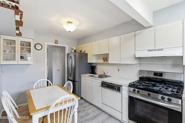 a kitchen with stainless steel appliances granite countertop a stove a refrigerator and a stove