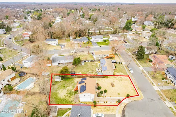 an aerial view of residential houses with outdoor space