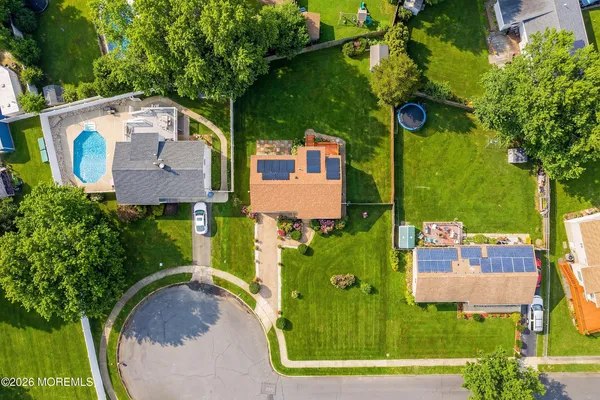 an aerial view of a house with garden space and a street view