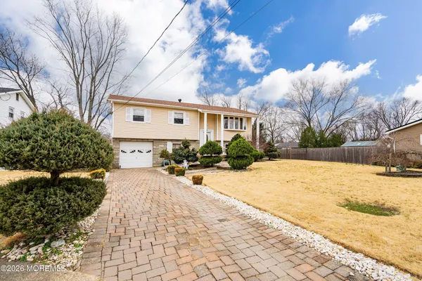 a front view of a house with a yard and a garage