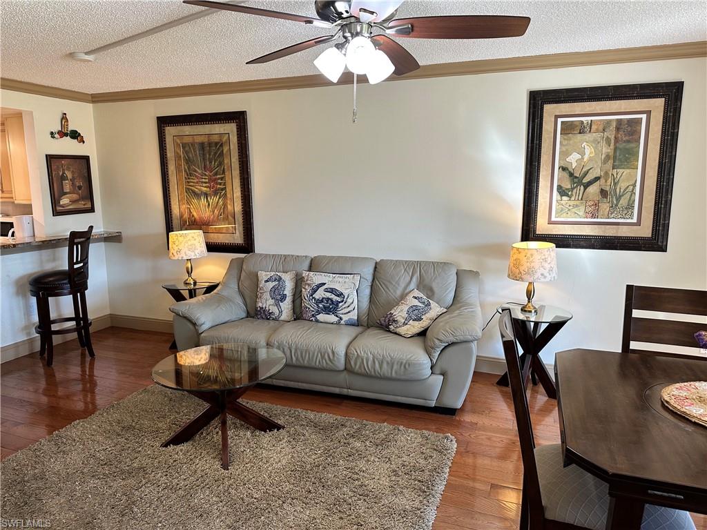 a living room with furniture and a dining table