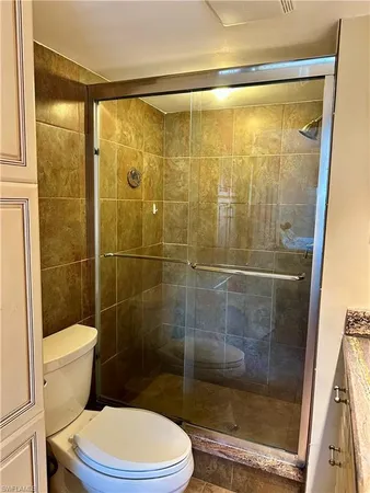 a bathroom with a shower a toilet and a sink