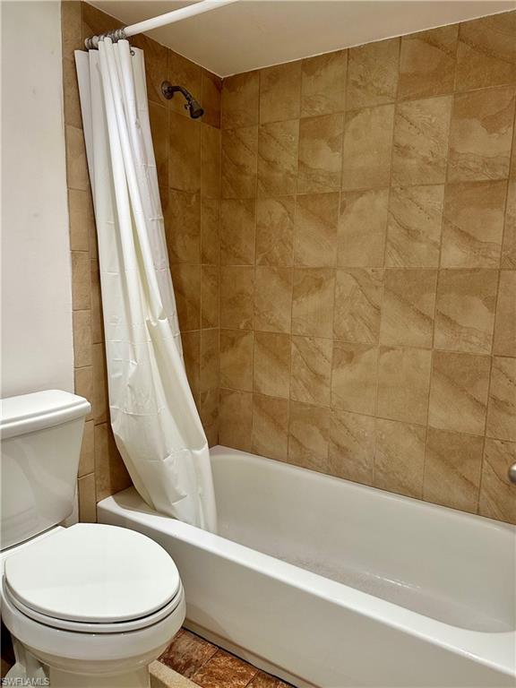 190 Turtle Lake Court, Unit 202 Naples, FL 34105 - Photo 8 of 10 a white toilet sitting next to a bath tub and a shower