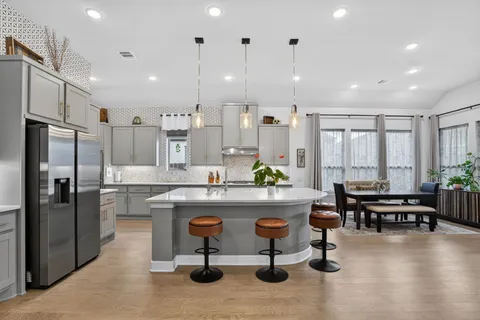 a kitchen with kitchen island granite countertop lots of counter top space and stainless steel appliances