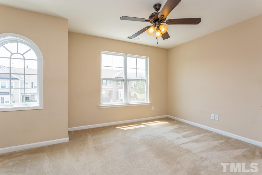 2946 Casona Way Raleigh, NC 27616 - Photo 14 of 25 an empty room with windows and fan
