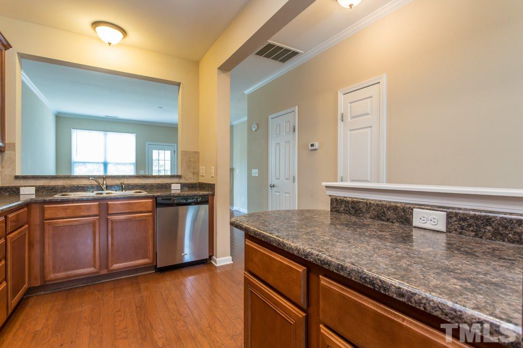 2946 Casona Way Raleigh, NC 27616 - Photo 6 of 25 a kitchen with stainless steel appliances granite countertop a sink and a stove