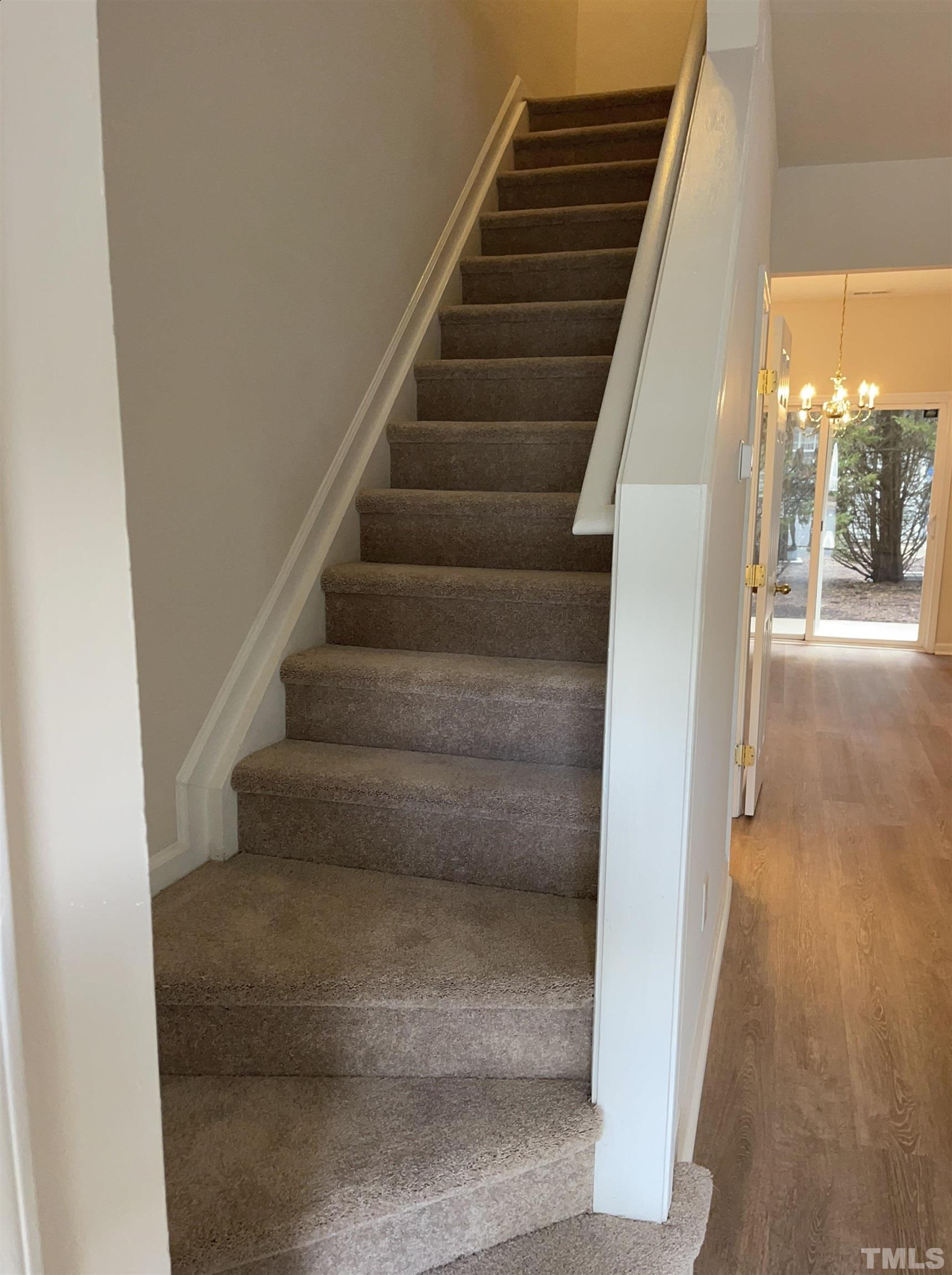 8513 Bright Loop Raleigh, NC 27613 - Photo 13 of 25 a view of staircase with white walls and windows