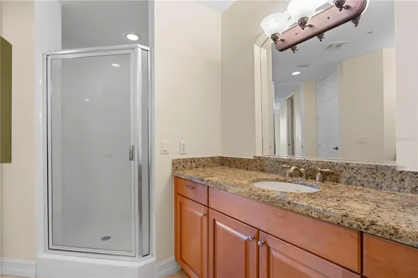 a view of a room with wooden floor and a bathroom view