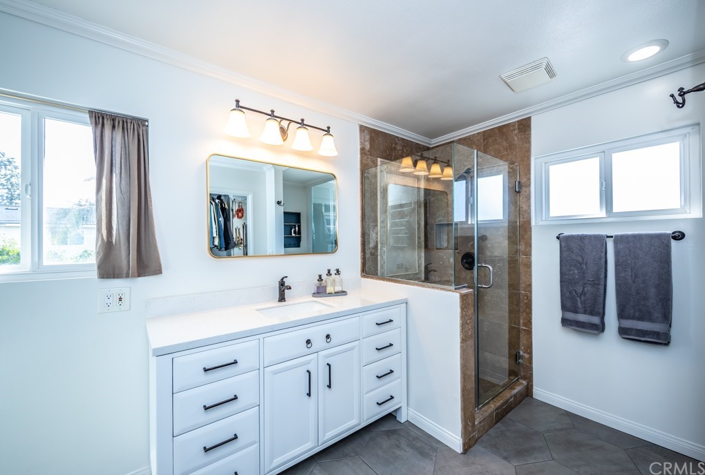 2114 Heloise Way Placentia, CA 92870 - Photo 38 of 61 a spacious bathroom with a double vanity sink a large mirror and shower