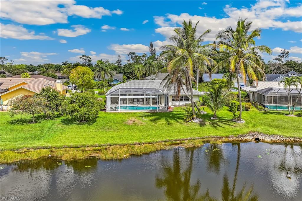 1904 Countess Court Naples, FL 34110 - Photo 26 of 33 a view of a lake with a house in the background