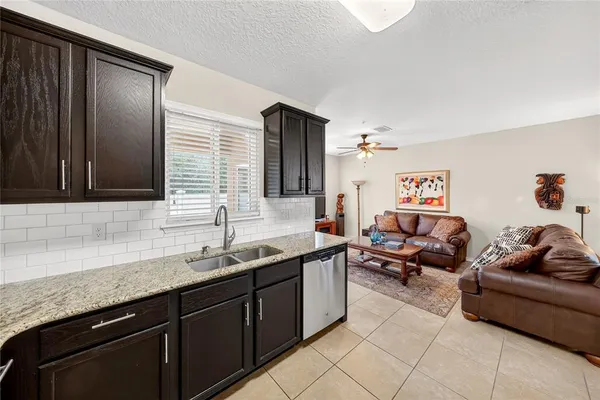 a spacious bathroom with a granite countertop sink and a mirror