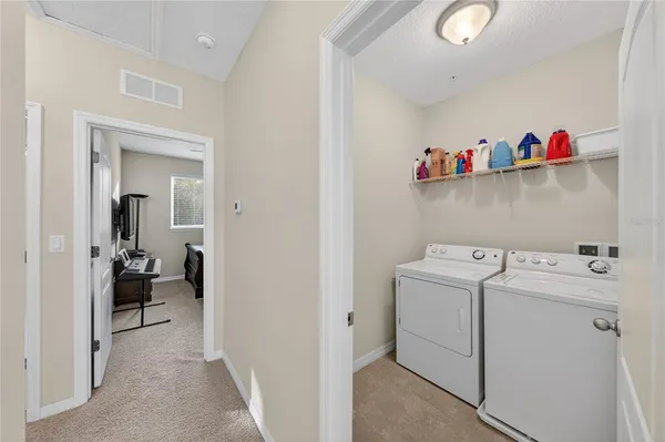 a view of storage and utility room with washer and dryer