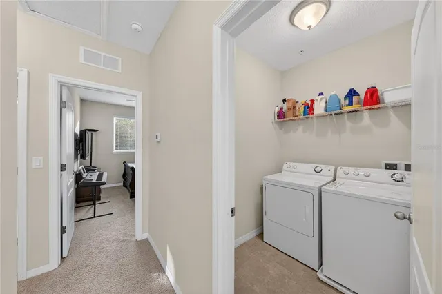 a view of storage and utility room with washer and dryer