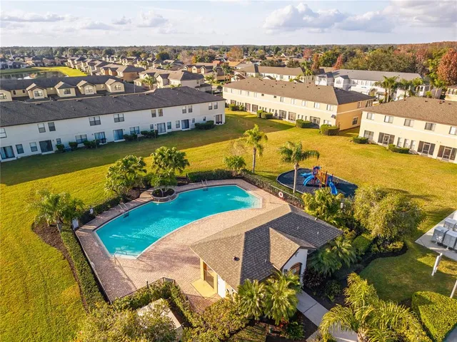 an aerial view of residential houses with outdoor space