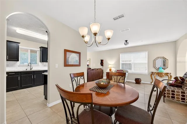 a view of a dining room with furniture and chandelier