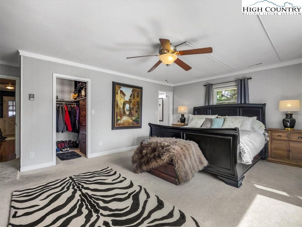 438 Glade Valley Road Glade Valley, NC 28627 - Photo 29 of 50 a bedroom with a bed and a chandelier