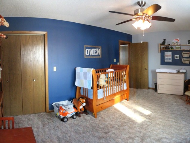 1202 Nelson Road Rock Falls, IL 61071 - Photo 22 of 31 a bedroom with a bed and a chandelier