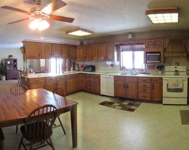 1202 Nelson Road Rock Falls, IL 61071 - Photo 9 of 31 a kitchen with granite countertop a stove a sink a window and chairs