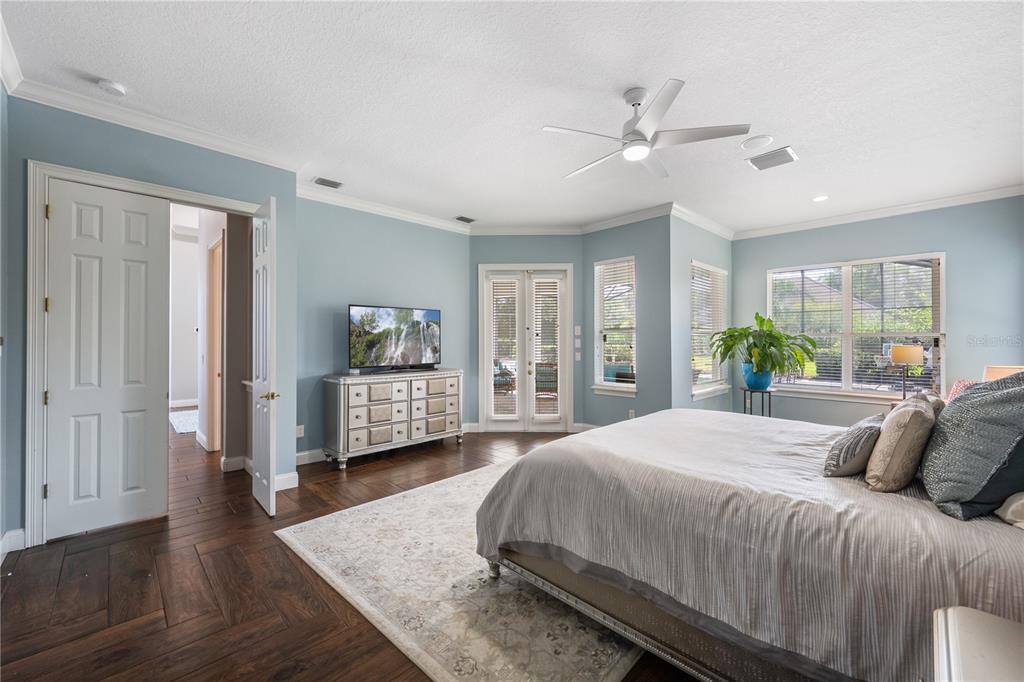 2002 Water Key Drive Windermere, FL 34786 - Photo 19 of 60 a spacious bedroom with a bed a dresser and a chandelier