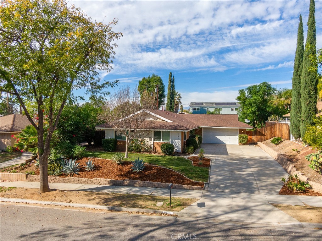 a view of a house with swimming pool and sitting area