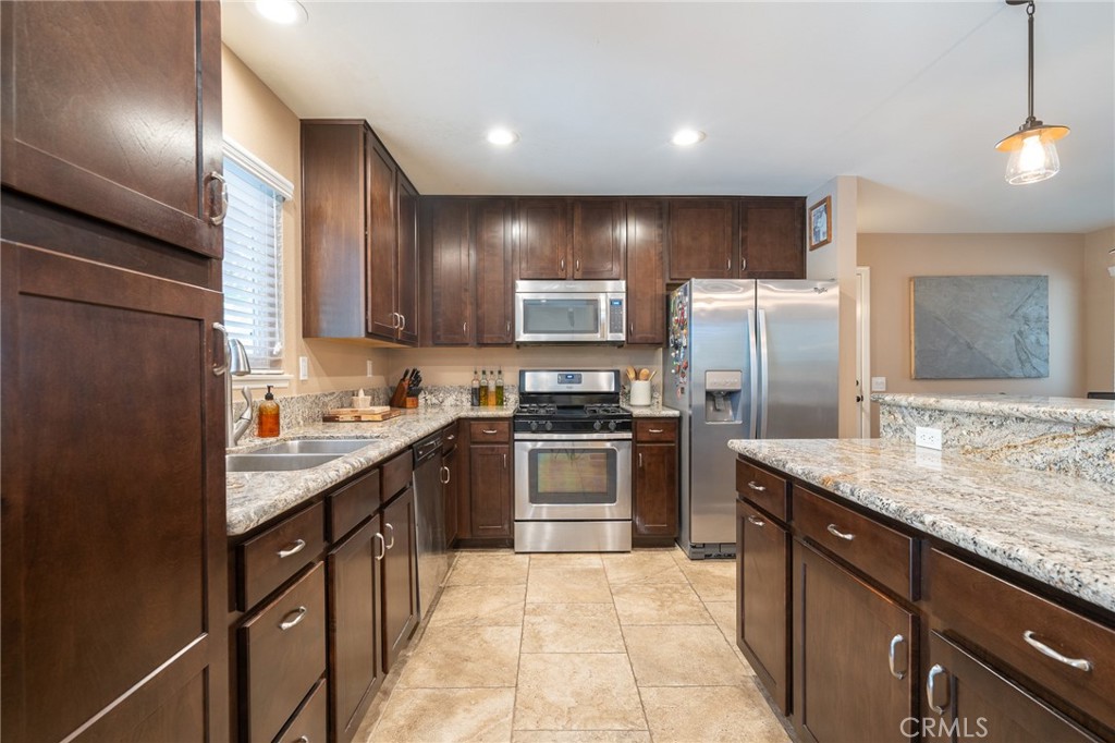 3165 Celeste Drive Riverside, CA 92507 - Photo 11 of 44 a kitchen with a sink stove and refrigerator