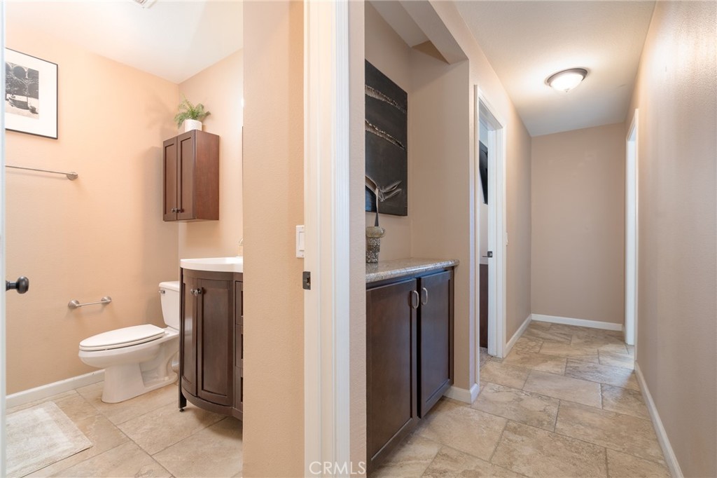 3165 Celeste Drive Riverside, CA 92507 - Photo 17 of 44 a bathroom with a toilet sink and mirror