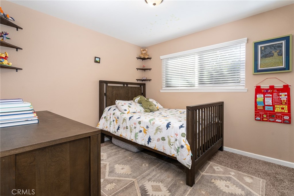 3165 Celeste Drive Riverside, CA 92507 - Photo 19 of 44 a bedroom with a bed and a table in it