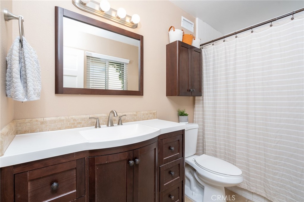 3165 Celeste Drive Riverside, CA 92507 - Photo 26 of 44 a bathroom with a sink vanity mirror and toilet