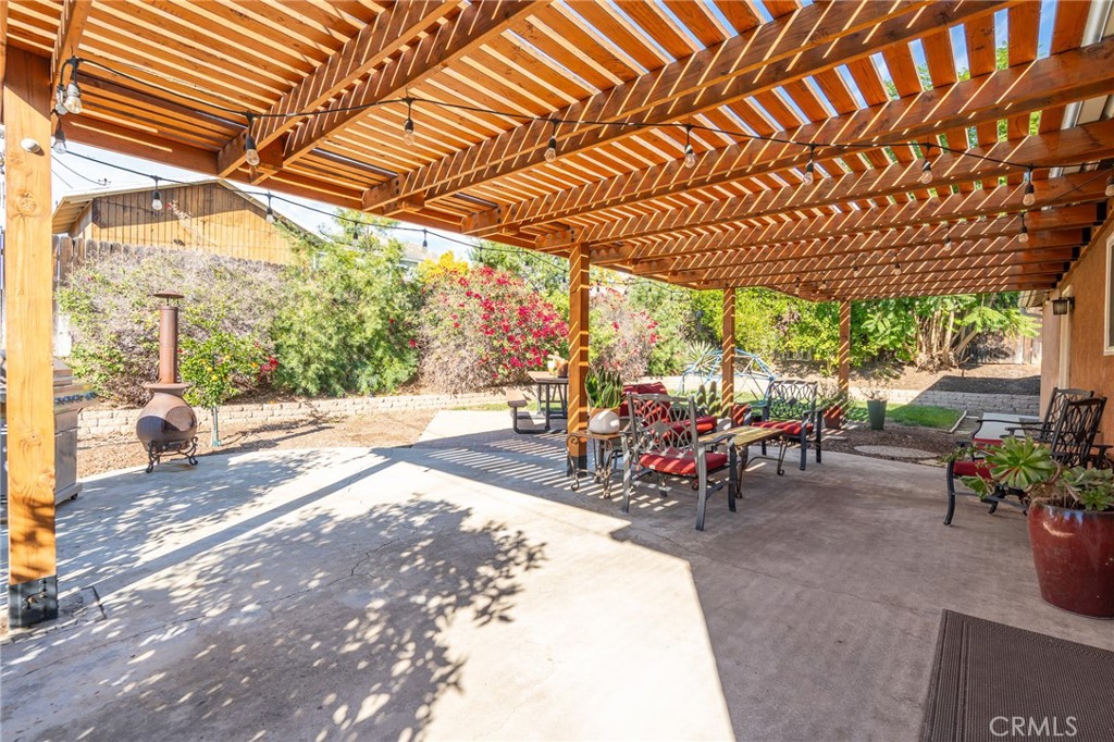 3165 Celeste Drive Riverside, CA 92507 - Photo 28 of 44 a view of a patio with table and chairs under an umbrella