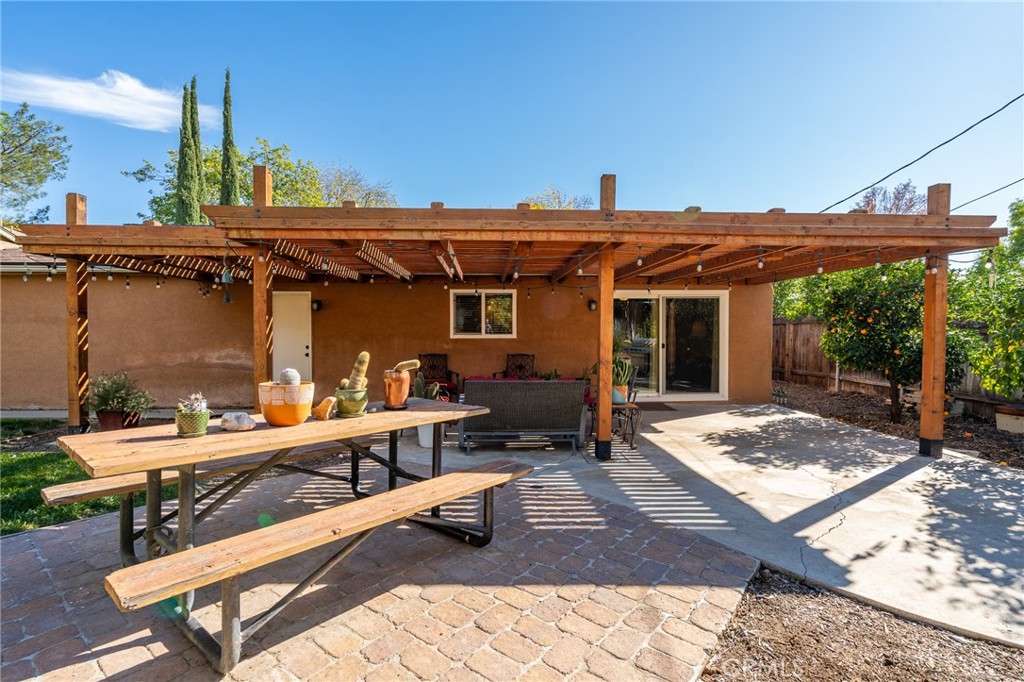 3165 Celeste Drive Riverside, CA 92507 - Photo 29 of 44 a view of a patio with table and chairs with wooden fence