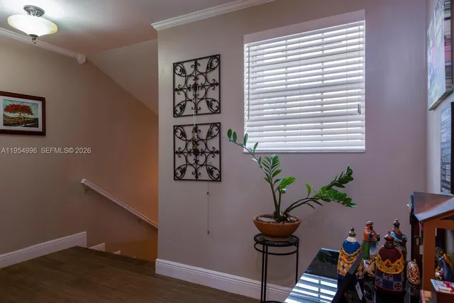a view of a workspace with furniture and a potted plant