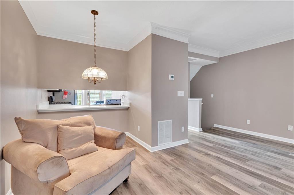 4005 Spring Cove Drive Duluth, GA 30097 - Photo 12 of 23 a living room with furniture a window and a chandelier