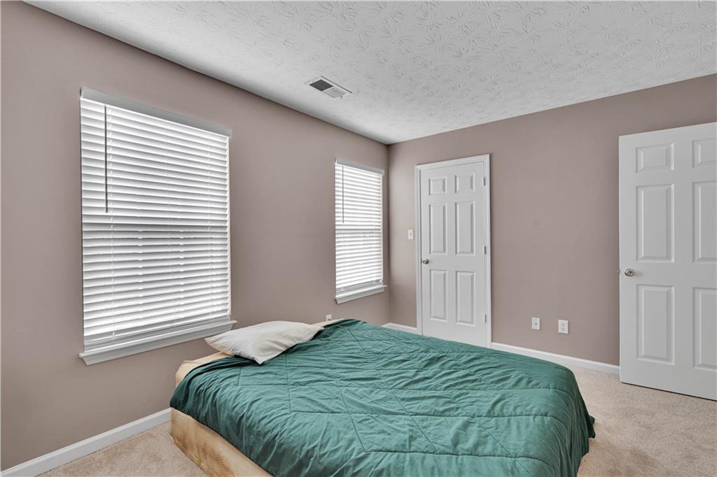 4005 Spring Cove Drive Duluth, GA 30097 - Photo 20 of 23 a bedroom with a bed and a window