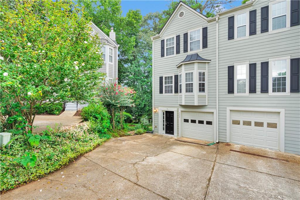 4005 Spring Cove Drive Duluth, GA 30097 - Photo 2 of 23 a view of a white house with a yard and plants
