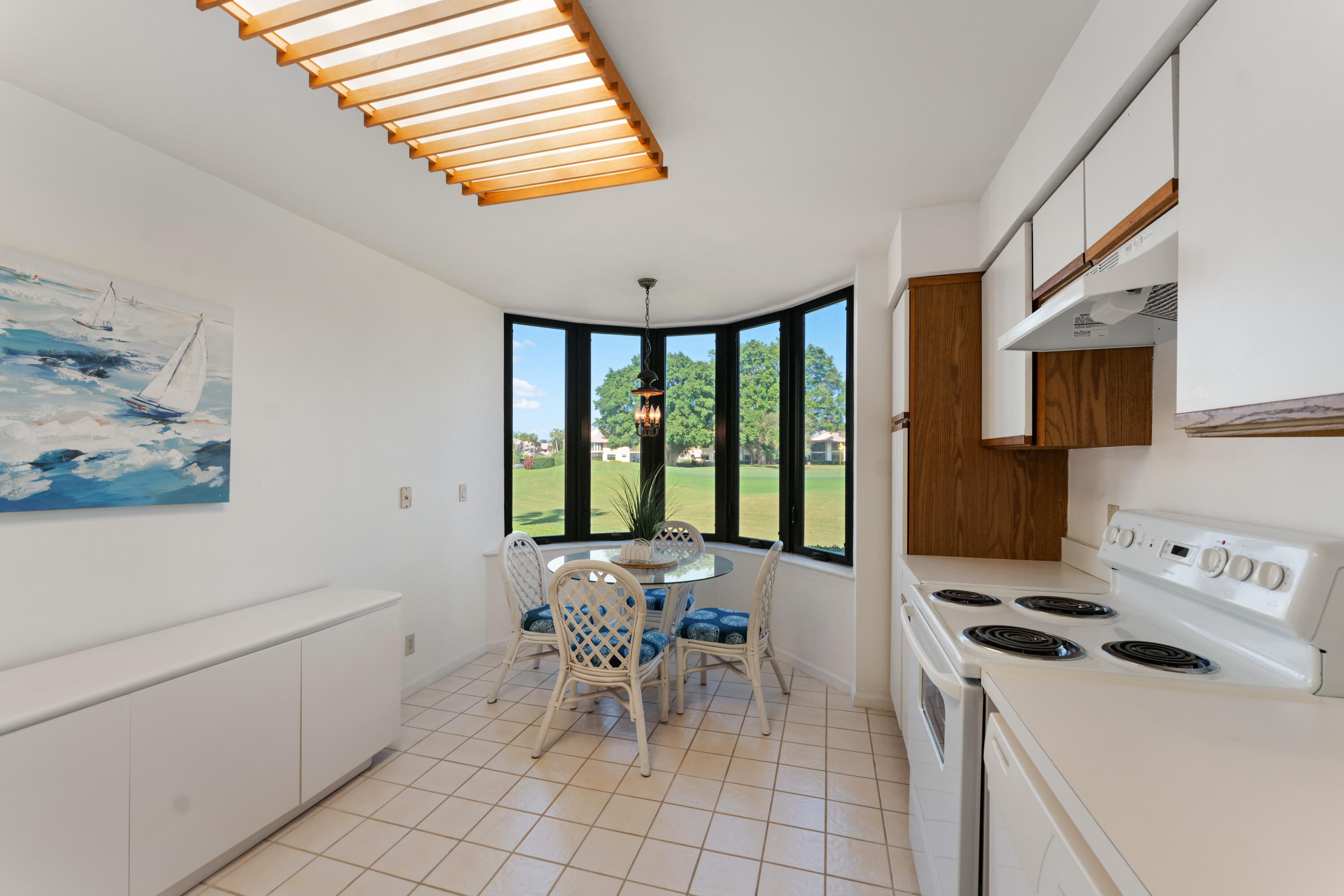 16970 Waterbend Drive, Unit 146 Jupiter, FL 33477 - Photo 13 of 30 a kitchen with a stove a sink and a refrigerator