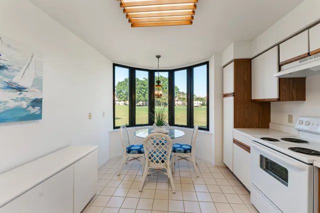 a living room with furniture a flat screen tv and a window