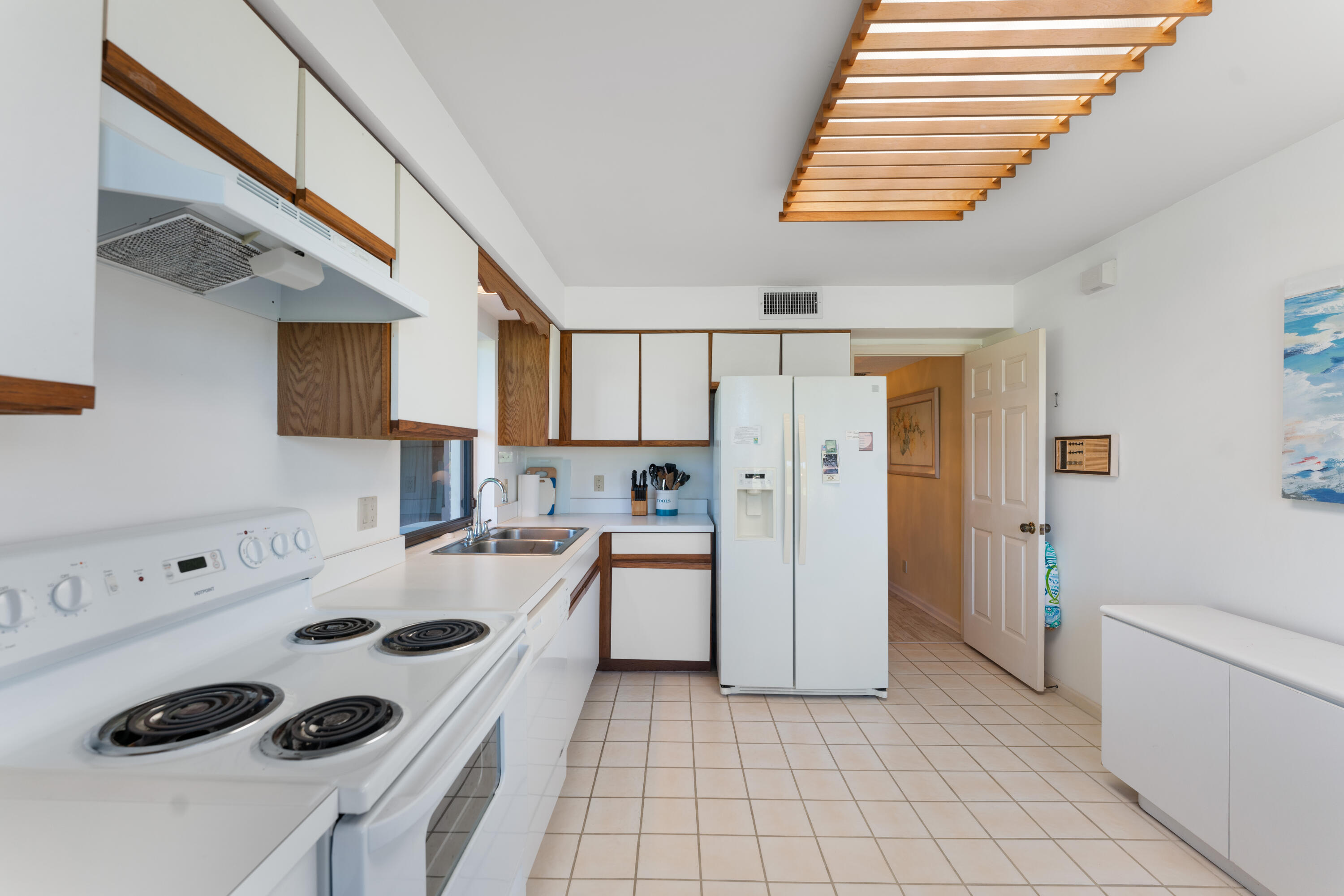 16970 Waterbend Drive, Unit 146 Jupiter, FL 33477 - Photo 16 of 30 a kitchen with a refrigerator a stove top oven a sink and cabinets